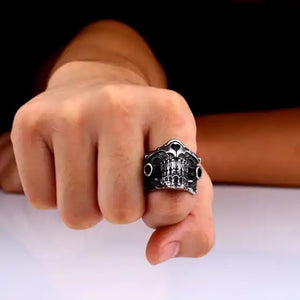 silver ring with lower half of mechanical skull on finger