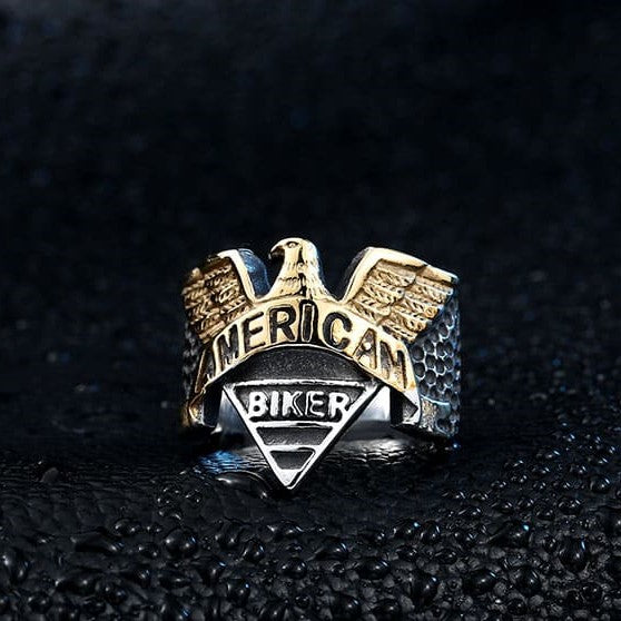 silver and gold biker ring with eagle and text that says american biker