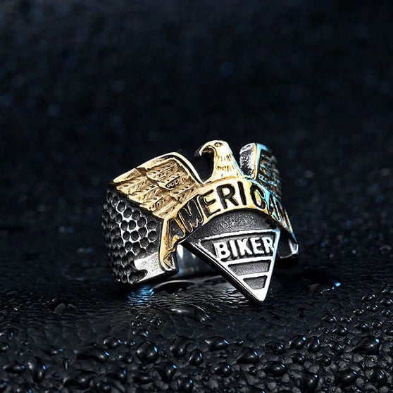 silver and gold biker ring with eagle and text that says american biker