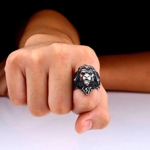 silver ring of a lion's head worn on a finger