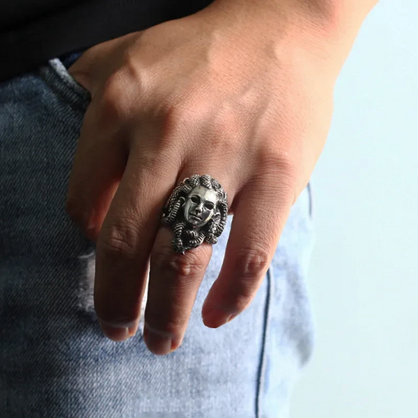 silver medusa head ring on finger