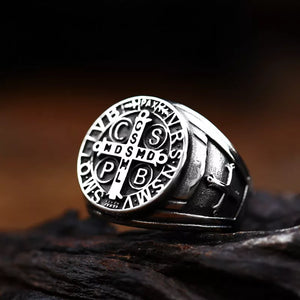 silver saint benedict ring with cross and inscription stating CSSML