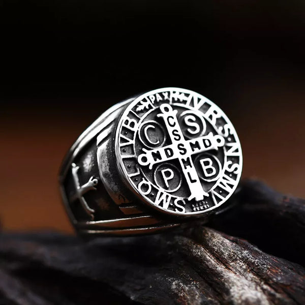 silver saint benedict ring with cross and inscription stating CSSML