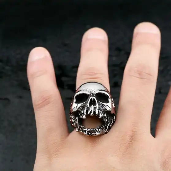 silver ring with screaming skull worn on finger
