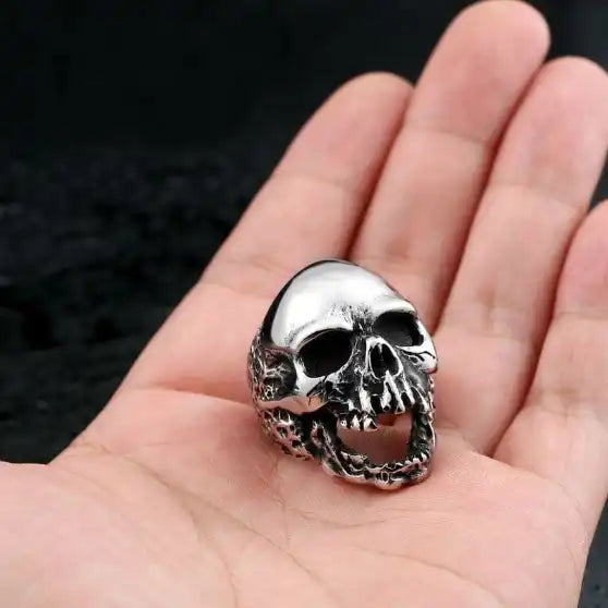 silver ring with screaming skull held in hand