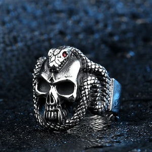 silver ring of skull with snake with red eyes wrapped around head