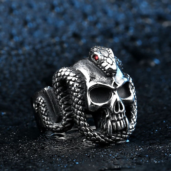 silver ring of skull with snake with red eyes wrapped around head