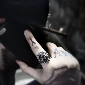 man with tattoos wearing silver ring of roaring tiger head