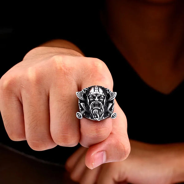 silver ring with bearded viking warrior and dual axes on finger