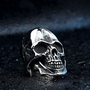 silver ring of skull inside battered helmet