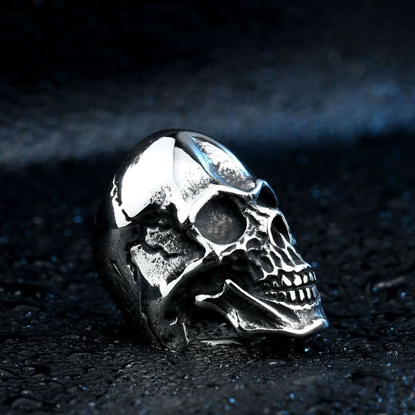 silver ring of skull inside battered helmet